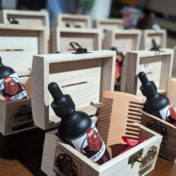 StayPut water-resistant enhancement spray placed with wooden combs and styling tools, demonstrating the product in a professional grooming environment.